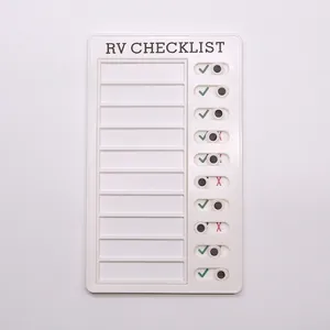 Detail of white RV checklist memo board with 10 sliding task markers on a grey background