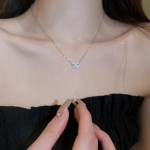 Minimalist silver butterfly necklace with colorful zircon stones on female model