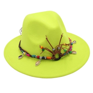 Detail of neon green fedora featuring ethnic beaded band with shells and leather tassels