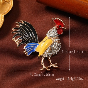 Macro shot of colorful enamel rooster brooch with white crystals and size measurements