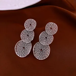 Three-tier hollow woven silver hoop earrings in a minimalist layered dangling style