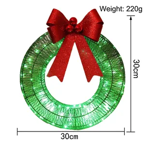 30cm Christmas metal wreath with large red bow and warm LED lights on white background