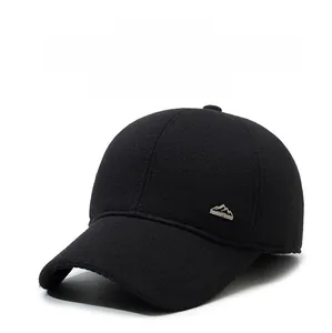 Close-up of winter baseball cap with ear flaps and silver mountain emblem detail