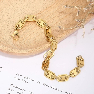 Detail of gold pig nose chain bracelet with coffee bean links and lobster clasp closure