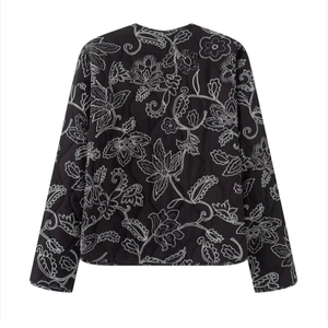 Women's black quilted jacket with large white floral embroidery on the back view