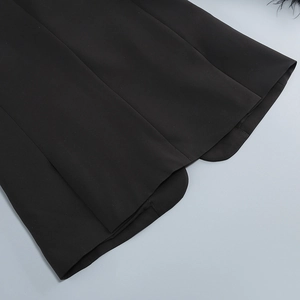 Detail view of the black jacket rounded hem and high-quality stitching on plain weave fabric