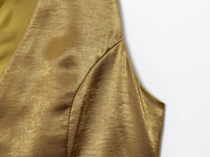 Detail of satin fabric texture with golden button on a luxury women outfit