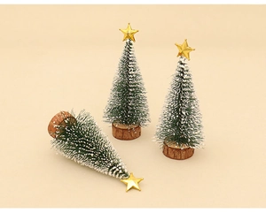 Detailed view of three mini frosted Christmas trees with gold stars and wooden bases