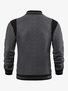 Detail view of athletic baseball jacket back with grey and black patchwork ribbing design