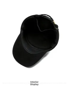 Close-up of black flat top cap interior lining with adjustable gold buckle and neat stitching
