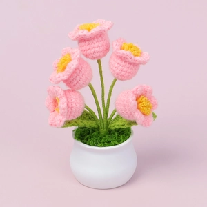 Handmade crochet Lily of the Valley flower in a white ceramic pot with pink blossoms