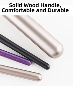 Close-up of solid wood makeup brush handles in champagne gold and matte black finish