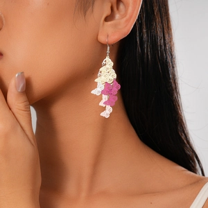 Detail of gradient pink butterfly tassel earrings on model for a bohemian look
