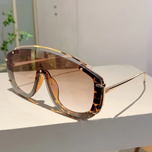 Detail of fashion oversized flat top sunglasses with tortoiseshell accents and metal beam