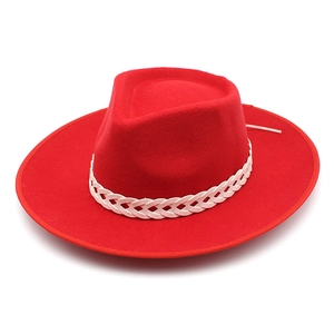 Detailed view of red wool fedora hat featuring a white braided band and wide flat brim