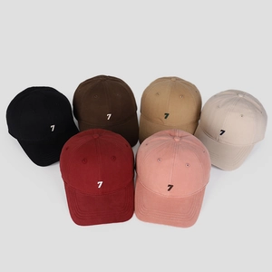 Detail of six cotton baseball caps with embroidered number 7 in diverse colors