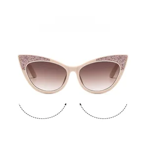 Close-up of cat-eye kids sunglasses with glitter accents and brown gradient lenses