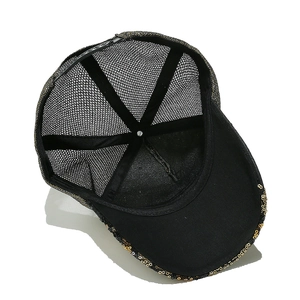 Detail of the black and gold mesh cap with sparkling sequins and adjustable strap