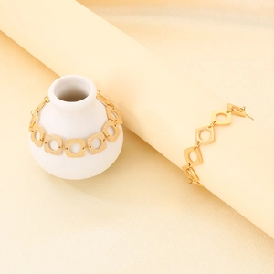 Détail rapproché du bracelet géométrique plaqué or 18 carats avec maillons carrés évidés