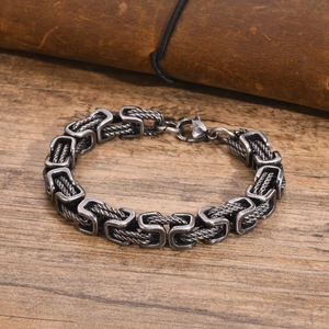 Vintage stainless steel Byzantine chain bracelet for men with lobster clasp on wood surface