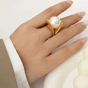Y-shaped thick 18k gold plated titanium steel ring with oversized white faux pearl detail