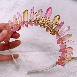 Detail view of boho crown with pink crystals and golden moon charms on a headband