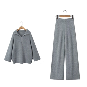 Grey knit two-piece set featuring half-zip sweater and wide-leg pants on hanger