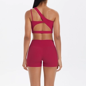 Rear view of deep red yoga set with asymmetric straps and cut-out back detail