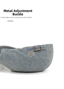 Detail of adjustable metal buckle and washed blue denim texture on the beret cap