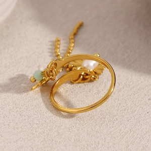 18K gold plated stainless steel open ring featuring a pearl, green bead, and chain tassel