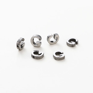Detail of six silver-grey metal letter G charms with 1.8mm hole for DIY jewelry making