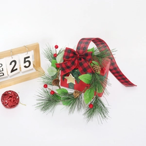 Christmas cabinet wreath with pine needles, red berries, and black-red checkered bow decoration