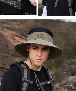 Detail of khaki outdoor sun hat featuring black breathable mesh and traveller embroidery