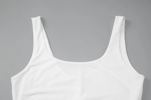 Detailed close-up of white knitted dress fabric showing soft texture and stitching quality