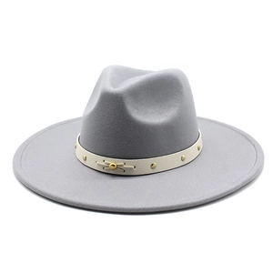 Detailed macro view of the felt wool fedora with gold rivet trim and beige ribbon band