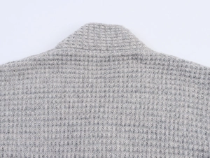 Detailed view of the waffle knit texture and stitching on a gray cashmere cardigan