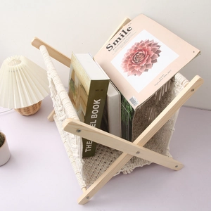 Close-up of Nordic woven cotton rope magazine rack with a foldable wooden X-frame stand