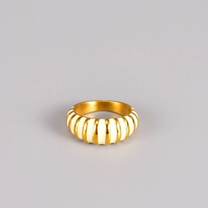 Macro view of a vintage ribbed dome ring with golden finish and cream enamel inlay stripes
