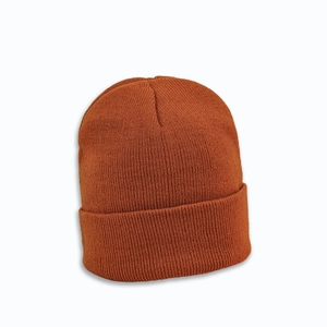 Close-up of caramel brown ribbed knit beanie showing thick texture and folded cuff