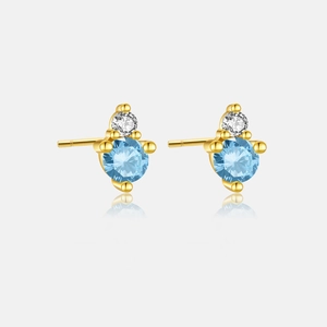 Close-up of S925 silver gold-plated stud earrings with blue topaz and zircon stones