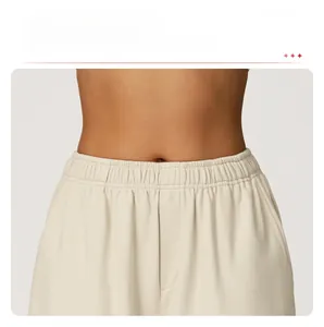 Detail of high-waist elastic waistband on beige wide-leg joggers for comfortable fit