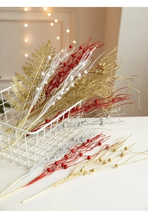 Close-up of glittery Christmas tree branches in gold, red and silver for festive decor
