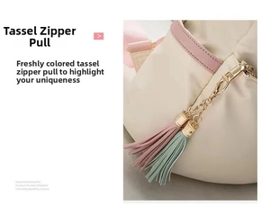 Detail of dual tassel metal zipper in pink and cyan on beige Oxford backpack