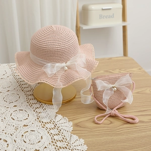 Pink woven straw sun hat and matching bag set with lace bows and pearl accents