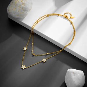 Double-layered gold necklace with white shell star pendants and dainty bead chain layers
