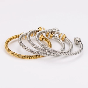 Twisted cable wire open cuff bracelets in gold and silver finish with pearl accents