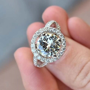 Classic round brilliant halo engagement ring with pavé band in polished silver