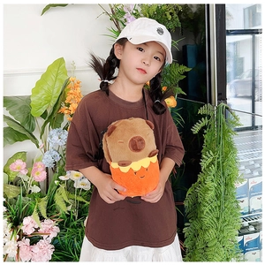 Child wearing a cute plush capybara crossbody doll bag with an adjustable strap