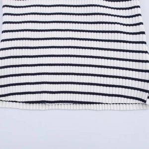 Close-up detail of black and white ribbed knit fabric with horizontal striped pattern