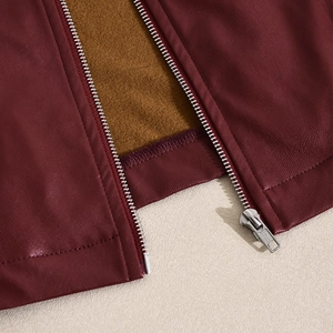 Detail of burgundy PU leather jacket featuring silver zipper and cozy fleece lining